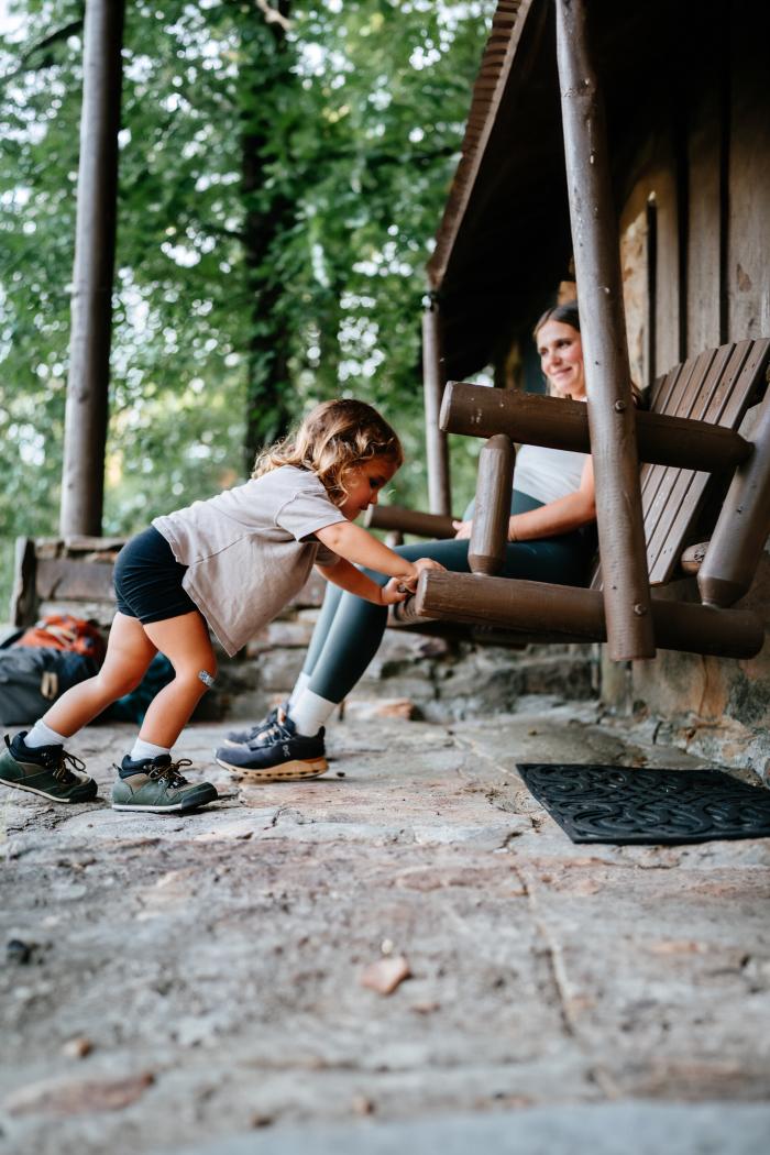 A girl and mother sitting on a bench