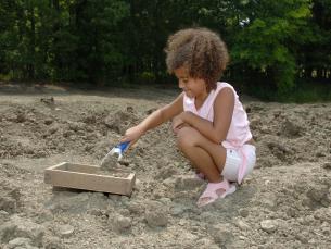 child searching for diamonds using a screen