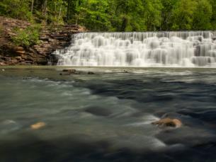 Water cascading over the dam at Devil's Den State Park