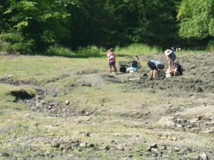 Crater of Diamonds State Park Search Field with family searching for diamonds in the background