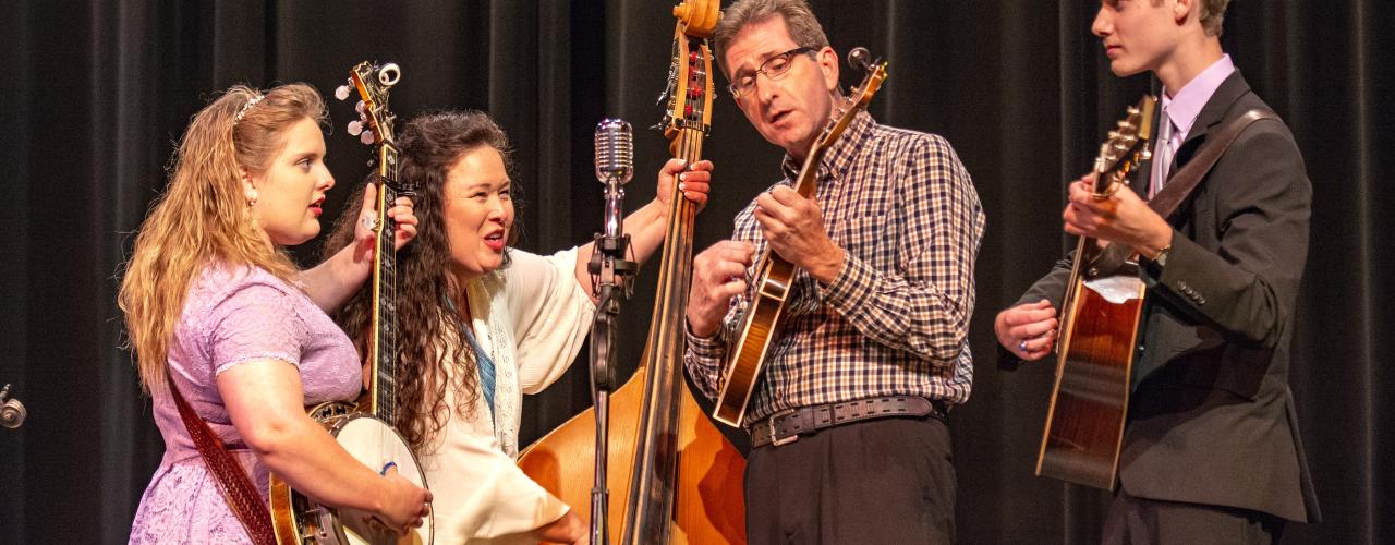 A bluegrass band playing a live show on stage at the Ozark Folk Center State Park