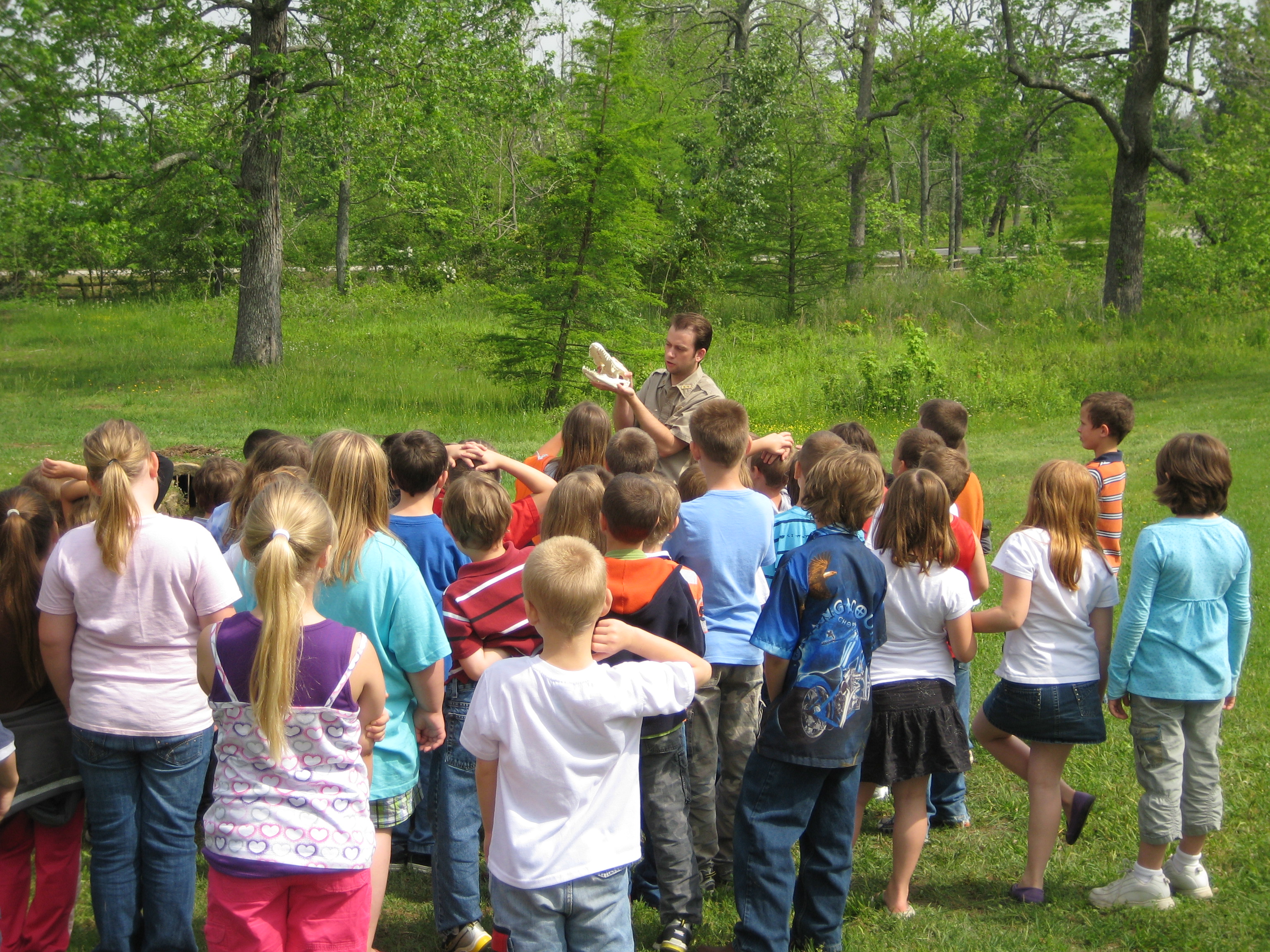 A group of students enjoys hands-on learning with a park interpreter.