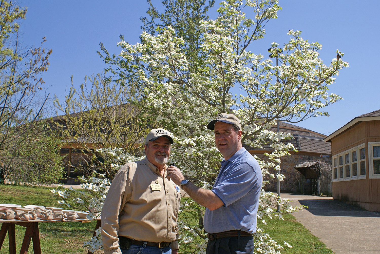 Ozark Folk Center’s Group Sales Manager Jimmie Edwards shares comments with KFFB’s General Manager Bob Connell.