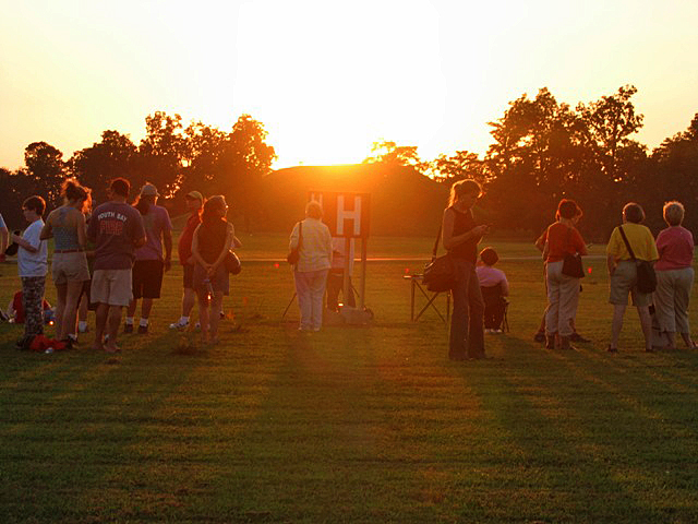 Visitors enjoying the sunset behind Mound A to mark the Fall Equinox.