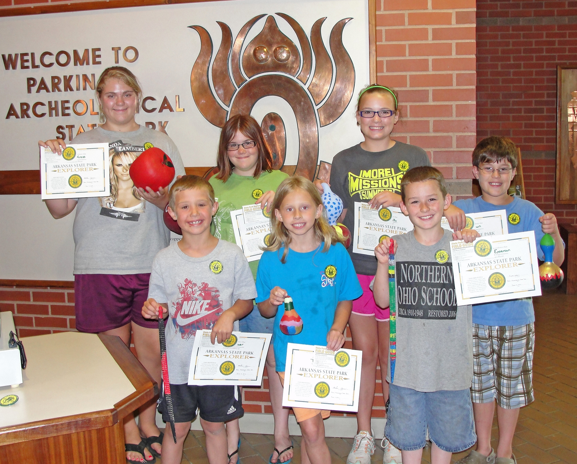 A group of kids receive their Explorer Certificates at Parkin Archeological State Park.